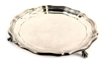 A George VI silver card tray, with piecrust border raised on three ball and claw feet, James Dixon a