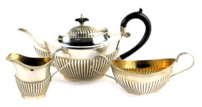 An Elizabeth II silver three piece tea service, comprising teapot, two handled sugar bowl and milk j