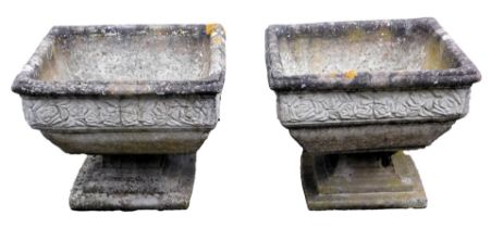 Two composition planters, of square form, decorated externally with floral motifs, on a stepped pede