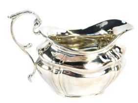 A Victorian silver cream jug, with acanthus leaf thumb piece, part reeded form, maker's mark rubbed,