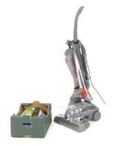 A Kirby Sentria upright vacuum cleaner, with accessories.