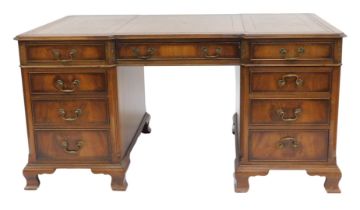 A Georgian style mahogany partner's desk, the gilt tooled brown leather top, over an arrangement to