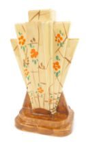 An Art Deco Myott Son and Co pottery fan shaped vase, decorated with orange flowers against a cream