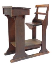 A Victorian pine teacher's school desk, the desk with a hinged lid, pen and inkwell recesses, on a t