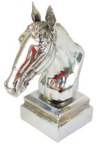 A silvered bust of a horse's head, on an integral square plinth base, 29cm high.