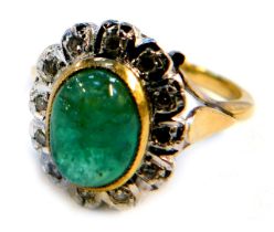 A cabochon emerald and diamond dress ring, on a yellow metal shank stamped 18ct, size P, 5.8g all