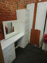 A part bedroom suite, comprising mirror back dressing table, a pair of two drawer bedside chests, an