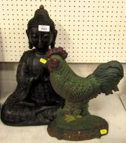 A cast metal figure modelled as a seated Buddha, 41cm high, together with a cast iron door stop mode