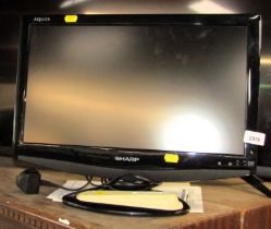 A Sharp Aquos 19" television, LC-19D1E-BK, with lead and remote.