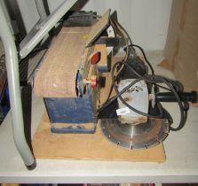 A Wickes electric disc cutter, together with an electric belt sander.