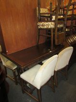 An oak draw leaf dining table, together with various chairs. The upholstery in this lot does not co