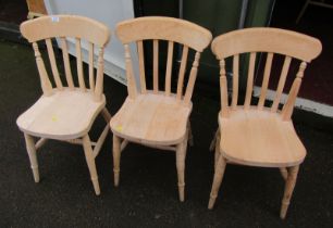 A set of three beech kitchen chairs.