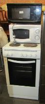 An electric cooker, together with a Cookworks 700w microwave, and a Daewoo microwave. (3) WARNING!