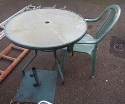 A metal framed garden table, with glass circular top, 70cm high, the top 90cm diameter, together wit