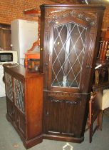 An oak Old Charm style standing corner cabinet, together with a similar display cabinet. WARNING