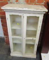 A painted wooden cabinet, with two glazed panelled doors enclosing an arrangement of shelves, 96cm h