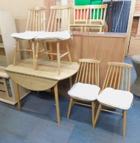 An oak effect drop leaf kitchen table, together with four spindle back Ercol style chairs.