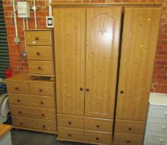 A simulated pine part bedroom suite, comprising triple wardrobe, chest of two short and three long d