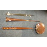 A copper warming pan, together with a copper hunting horn and brass fireside implements.