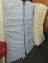 An Inner Wisdom single mattress, with bed base and further mattresses.