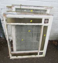 A group of stained and leaded glass window panels, with painted surrounds. (AF)