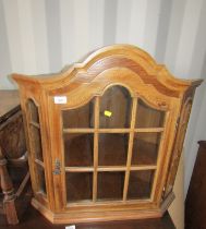 An oak corner cabinet, with panelled door, 69cm high.