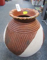 A pottery vase, of globular form with flared neck and incised decoration, 32cm high.