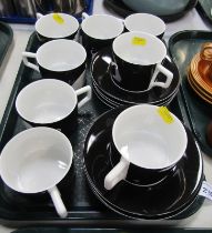 A Grand Hotel by Andrew Martin part coffee service, decorated with white elephants against a black g