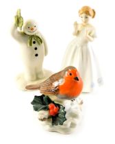 Three porcelain figures, comprising Royal Doulton Catherine, HN3044, a Beswick The Snowman figure, 1