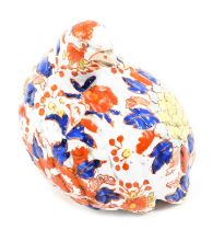 An Oriental ceramic bird, in the Imari painted style, seated with arched neck, with six character st