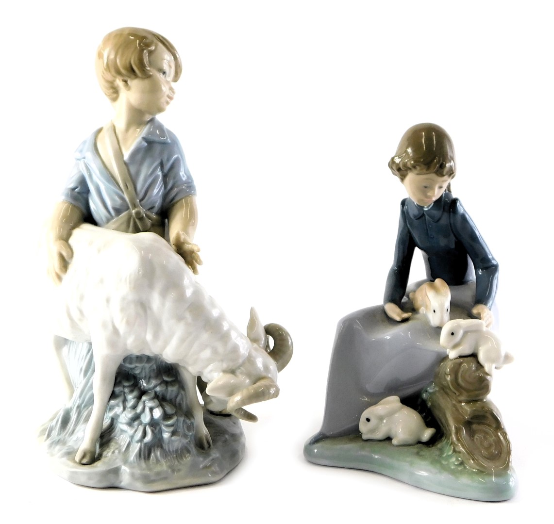 A Nao porcelain figure group, modelled as a young boy beside ram, printed marks, 20cm high, together