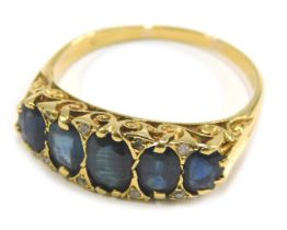 An 18ct gold sapphire and diamond half hoop dress ring, set with five oval sapphires each in claw se