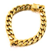 A heavy curb link bracelet, yellow metal stamped 18kt, 21cm long, 71.2g all in.