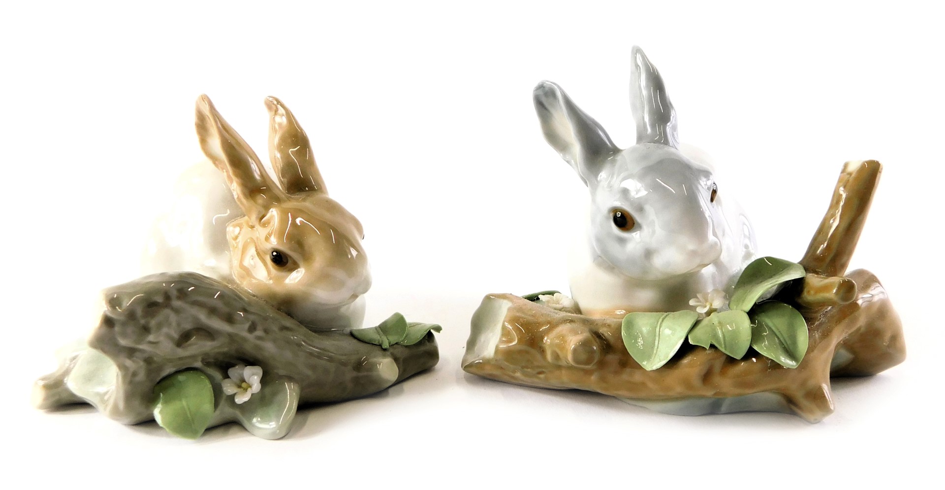 Two Lladro porcelain figures modelled as rabbits beside flowering tree branch, printed marks, 10cm h