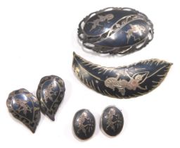 A group of Middle Eastern jewellery, comprising an oval twist design brooch with Nepalese style figu