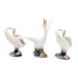 Three Lladro porcelain figures modelled as swans, in differing poses, the largest 13cm high.