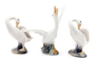 Three Lladro porcelain figures modelled as swans, in differing poses, the largest 13cm high.