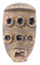 A Grebo (Kru) six eyed warrior mask with evidence of faded kaolin, Liberia, approximately 40 years o