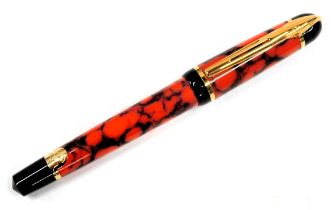 A Waterman of Paris fountain pen, in red and black marbled casing, in outer presentation box.