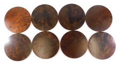 A set of eight Linley figured and burr walnut placemats, 28cm diameter.
