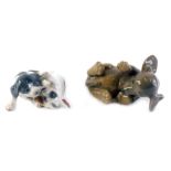 A Royal Copenhagen porcelain puppy, numbered 1408, and a figure group of two puppies with spotted de