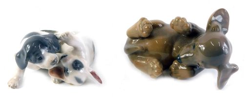 A Royal Copenhagen porcelain puppy, numbered 1408, and a figure group of two puppies with spotted de