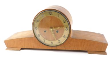 A 1950s light oak cased mantel clock, with gold coloured chapter ring, 50cm wide.