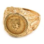 A 9ct gold coin set dress ring, the central Liberty quarter dollar, in a bark effect ring mount, rin