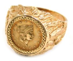 A 9ct gold coin set dress ring, the central Liberty quarter dollar, in a bark effect ring mount, rin