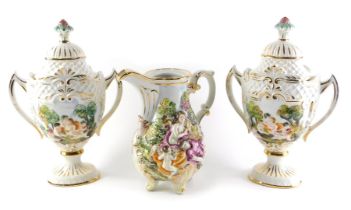 A pair of Capodimonte two handled urns and covers, decorated in relief with putti, 37cm high, and a