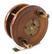 A mahogany and brass fishing reel stamped Carter & Co London, 9cm diameter.