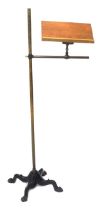 A Victorian adjustable brass music stand, with cast iron base.