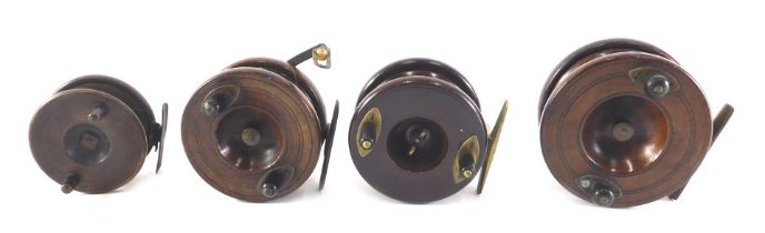 A collection of mahogany and brass fishing reels, various sizes, the largest 10cm diameter.
