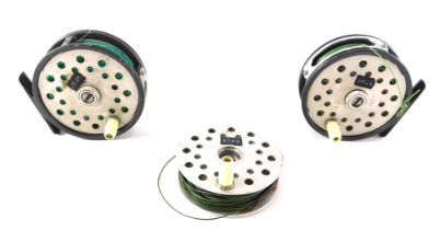 Two Japanese aluminium and metal fly fishing reels, 9cm diameter, and a spare spool. (3)